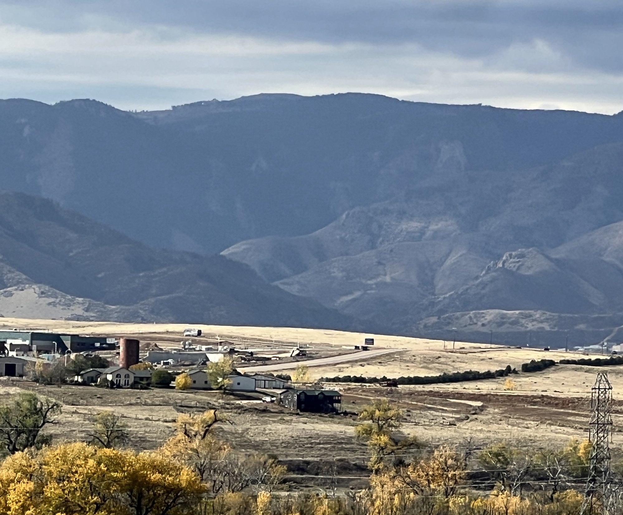 A farm below the Colorado foothills, with fall gold in the cottonwoods.